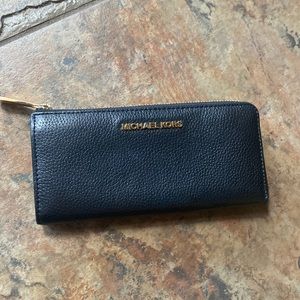 Black leather michael kors wallet. Three quarter zip slim